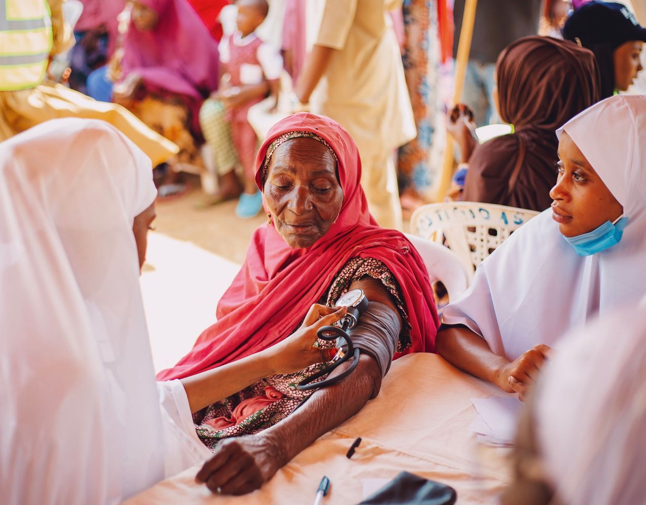 services-02 An outdoor health checkup for the elderly in Kaduna, Nigeria, emphasizing community care.